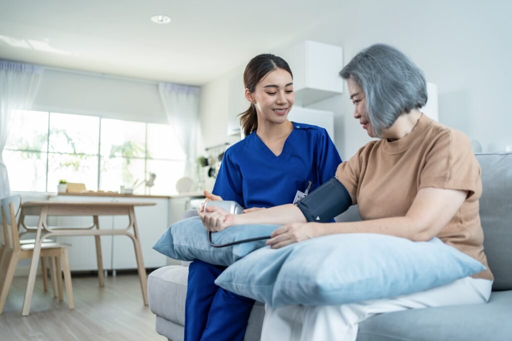 Asian caregiver doctor examine older patient use blood pressure gauge.