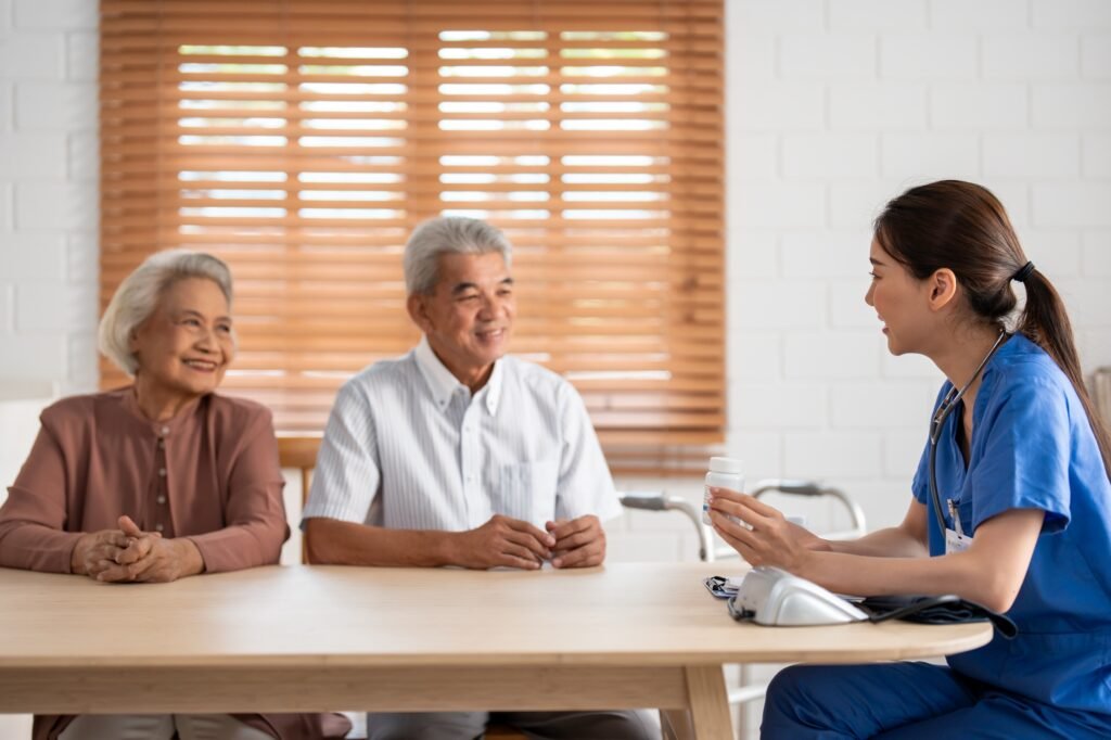 Asian caregiver nurse examine senior man and woman patient at home.